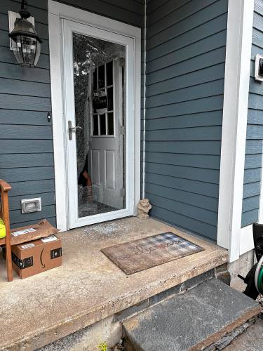 A glass storm door shattered by a bullet that hit a Mountain View Drive home last June. 