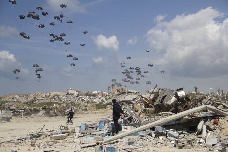 Humanitarian aid is airdropped to Palestinians over Gaza City, Gaza Strip, Monday. 