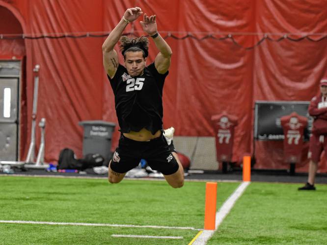 Juan Lua attempts the broad jump during UMass’ Pro Day on Tuesday afternoon in Amherst.