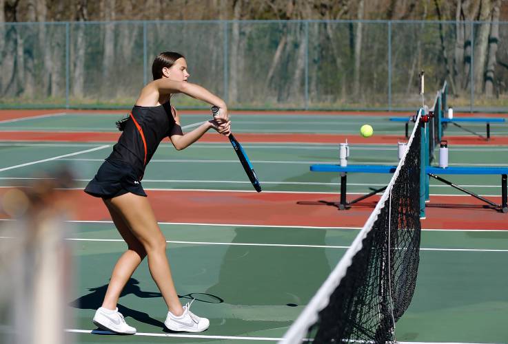 Belchertown’s Mia Corish volleys at the net while competing in the No. 1 doubles match with Emalee Chaisson against South Hadley’s Madison Bruso and Grace O’Shea 