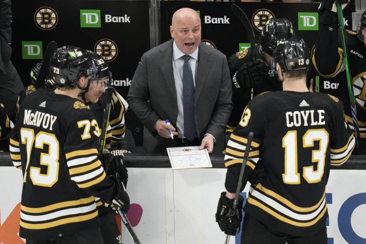 Boston Bruins coach Jim Montgomery discusses a play during the third period of the team's NHL hockey game against the Ottawa Senators, Tuesday, April 16, 2024, in Boston. (AP Photo/Charles Krupa)