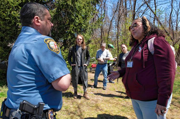 Shaundell Diaz, a coordinator entry specialist with the Three County Continuum of Care with Community Action Pioneer Valley, talks with Victor Caputo, captain of operations with the Northampton Police Department, around logistics for dispersing a homeless encampment off King Street. 