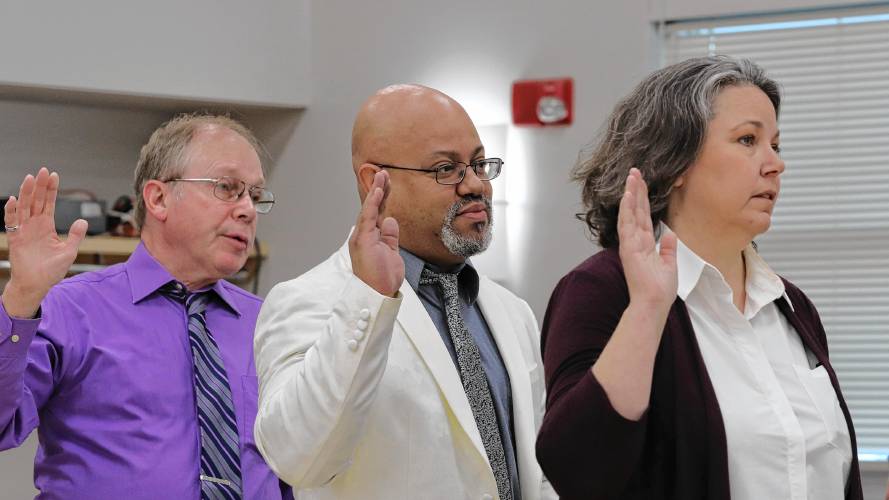 City Councilors Stanley Moulton, from left, Garrick Perry and Marissa Elkins are sworn in during an inauguration ceremony at the Northampton Senior Center on Tuesday.