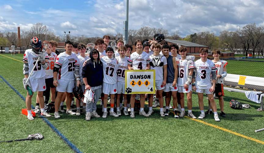 Owen Dawson (middle) poses with his teammates following South Hadley’s 15-4 win over Granby on Saturday. In the win, Dawson eclipsed the 200-point mark for his career thanks to a two-goal, three-assist performance.