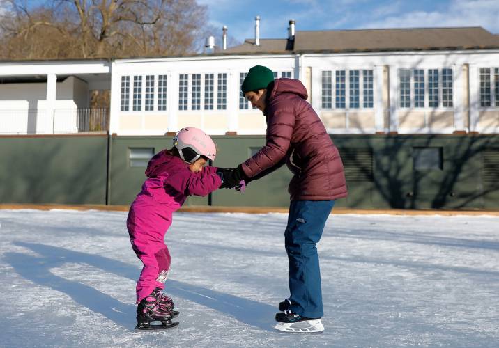 Margaret Shrayer-Griffith of Florence ventures onto the ice with her daughter Mona, 5, who was trying out ice skates for the first time Saturday afternoon at the Look Memorial Park skating rink in Florence.