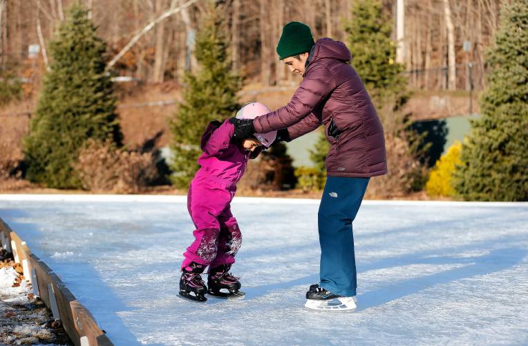 Margaret Shrayer-Griffith of Florence assists her daughter Mona, 5, who was trying out ice skates for the first time Saturday afternoon at the Look Memorial Park skating rink in Florence.