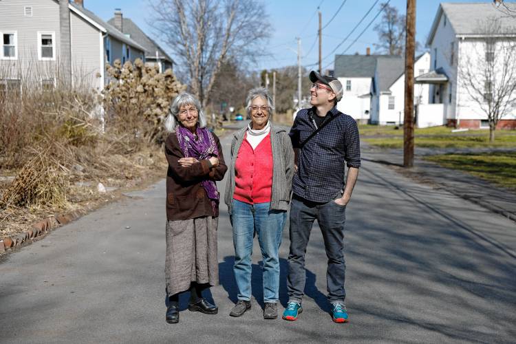 Claudia Lefko, Gail Hornstein and Ben James pose for a photo while walking through the Montview neighborhood in Northampton.