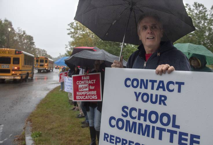Hampshire Regional High School teacher Warren Smith stands with other teachers and staff advocating for a fair contract in September 2023. The Hampshire Regional Education Association and the Regional School Committee recently settled the contract after more than a year of negotiations. 