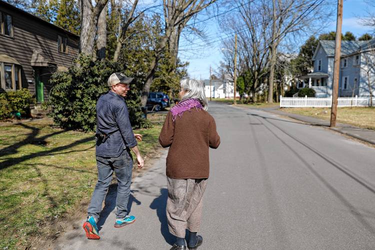 Ben James and Claudia Lefko walk through the Montview neighborhood along with Gail Hornstein, out of frame.