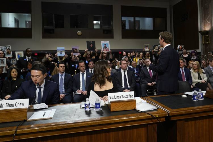 Meta CEO Mark Zuckerberg turns to address the audience during a Senate Judiciary Committee hearing on Capitol Hill in Washington, Wednesday, Jan. 31, 2024, to discuss child safety. TikTok CEO Shou Zi Chew and X CEO Linda Yaccarino listen. (AP Photo/Susan Walsh)