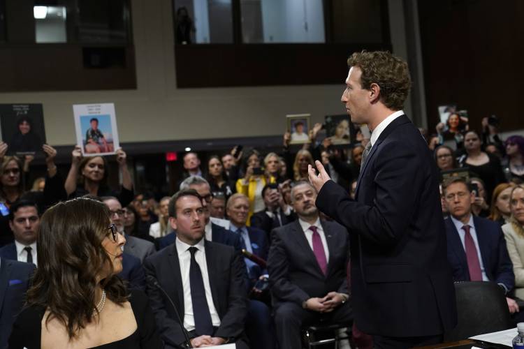 Meta CEO Mark Zuckerberg turns to address the audience during a Senate Judiciary Committee hearing on Capitol Hill in Washington, Wednesday, Jan. 31, 2024, to discuss child safety. X CEO Linda Yaccarino watches at left. (AP Photo/Susan Walsh)