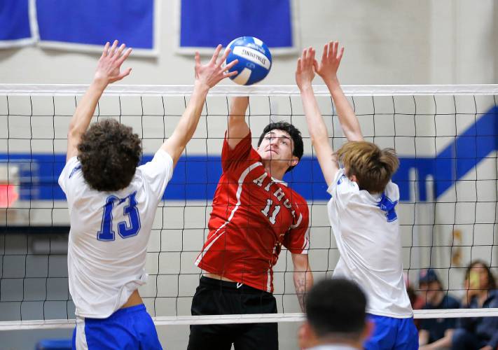 Athol’s Colin Mason (11) gets a kill over Granby’s Nicolas Grandmont (13) and Braeden Gallagher (4) in the second set Wednesday in Granby.