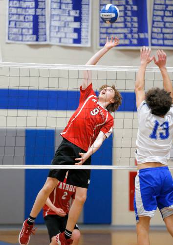 Athol’s Warren Taylor (9) tips the ball over Granby’s Nicolas Grandmont (13) in the second set Wednesday in Granby.