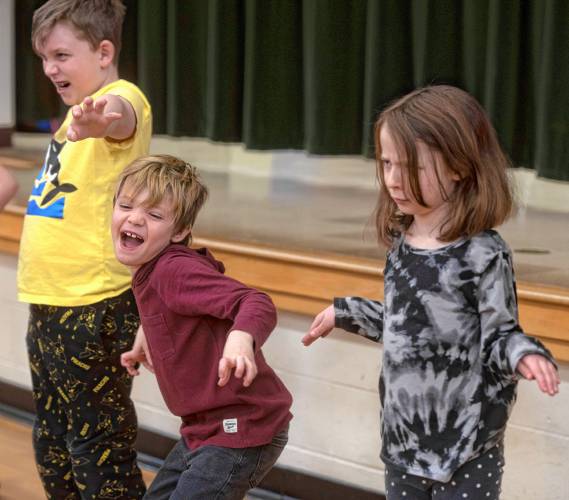 Boe Jackson acts like a Lion with, left, Lucca Rodney-Gage and Adalaide Elliott-Valerio during the culmination of an improvisation workshop taught by Jonathan Mirin, of the Piti Theatre Company, at the New Hingham Elementary School in Chesterfield.