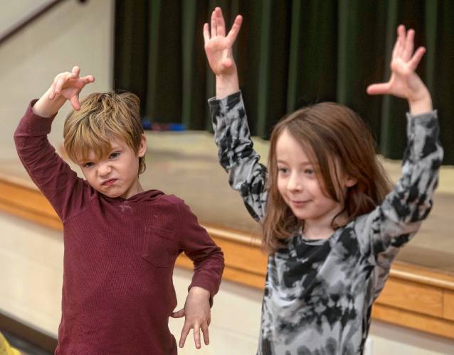 Boe Jackson acts like a giraffe with, left, Adalaide Elliott-Valerio during the culmination of an improvisation workshop taught by Jonathan Mirin, of the Piti Theatre Company, at the New Hingham Elementary School in Chesterfield.