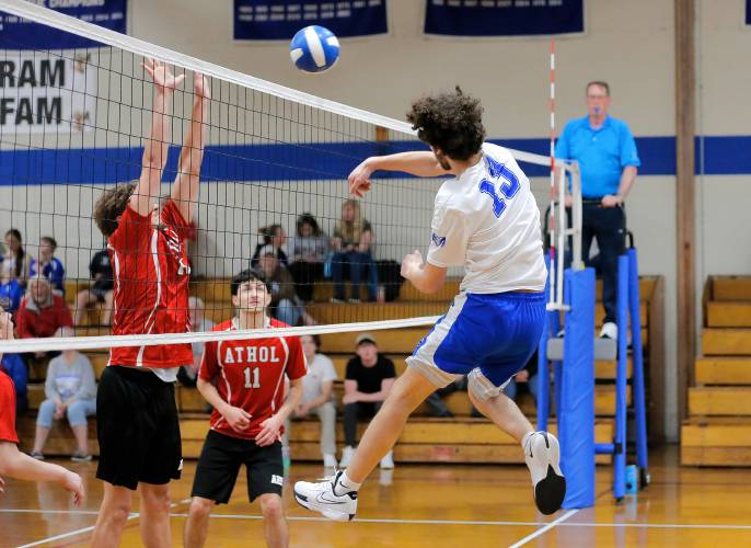 Granby’s Nicolas Grandmont (13) attacks at the net against Athol in the second set Wednesday in Granby.