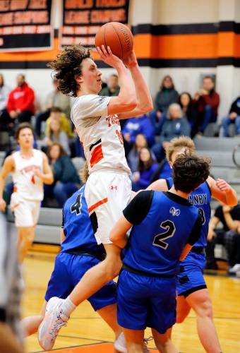 South Hadley’s Jack Loughrey (12) drives to the hoop against Granby in the third quarter Wednesday night in South Hadley.