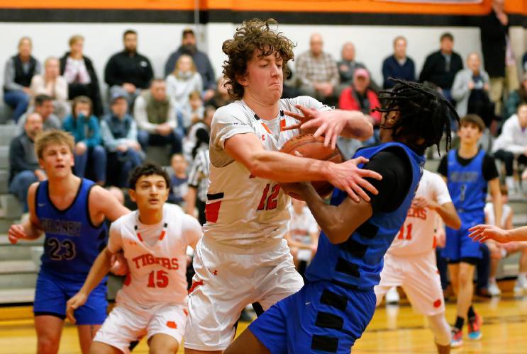South Hadley’s Jack Loughrey (12) rips the ball from Granby’s Gavier Fernandez (5) in the second quarter Wednesday night in South Hadley.
