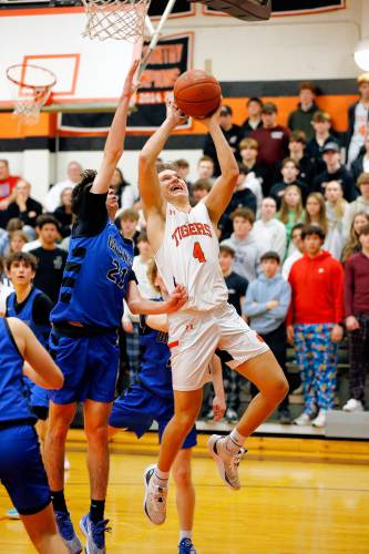 South Hadley’s Owen Dawson (4) drives to the hoop defended by Granby’s Gavin Moreno (3) in the fourth quarter Wednesday night in South Hadley.