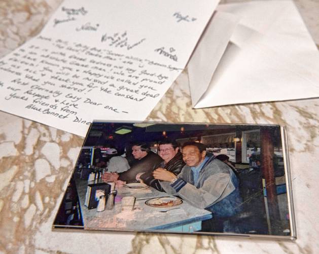 Bill Hairston, at right, with friends at the counter at Bluebonnet Diner with a  letter written to Hairston by the staff at the diner where he ate most days. Hairston, a longtime counselor at the Veterans Administration in Leeds, died March 22 at the age of 86. 