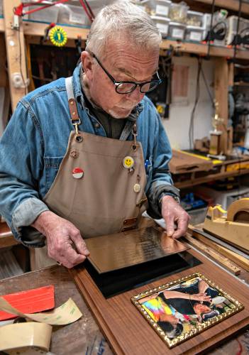 Rusty Wilkinson, owner of Award 1 Engraving, puts together a memorial plaque for Edward Hanlon Jr. and Ilona Murray, who were killed in August of 2022 crossing Northampton Street in Easthampton. The plaque is being donated by the Easthampton Council of Veterans Affairs. 