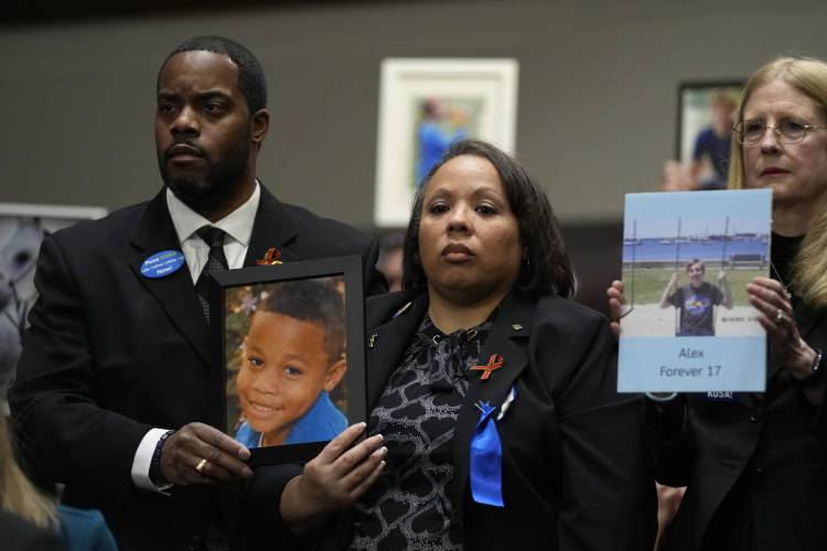 Todd and Mia Minor, both of Accokeek, Md., left, hold a photo of their son, Matthew Minor as they attend a Senate Judiciary Committee hearing with the heads of social media platforms on Capitol Hill in Washington, Wednesday, Jan. 31, 2024, on child safety. The Minor's son, Matthew Minor, died after a TikTok 