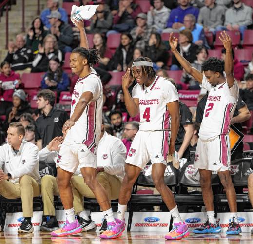 The UMass bench celebrates in the second half of the Minutemen’s 66-65 victory over George Mason on Saturday afternoon at the Mullins Center in Amherst.