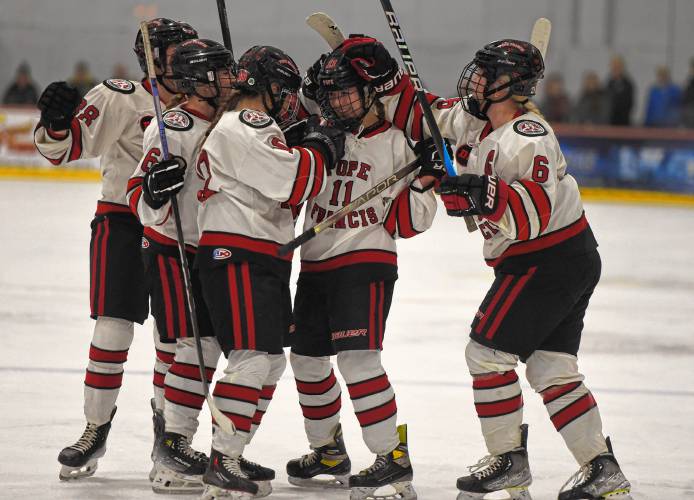 Pope Francis players celebrate around goal scorer Madison Dunaj (11) in the first period against Longmeadow on Wednesday night at Amelia Park Arena in Westfield.