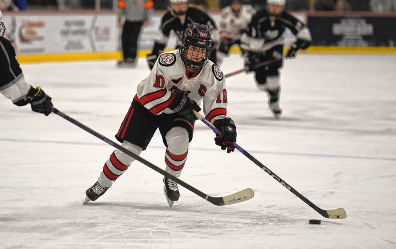 Pope Francis’ Lily Hayes (10) skates into the Longmeadow zone on Wednesday night at Amelia Park Arena in Westfield.