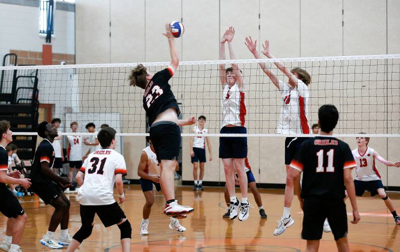 Belchertown’s Zach Dragon (23) attacks at the net against Frontier in the first set Tuesday in Belchertown.