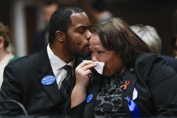 Todd Minor kisses his wife Mia Minor, both of Accokeek, Md., as they attend a Senate Judiciary Committee hearing with the heads of social media platforms on Capitol Hill in Washington, Wednesday, Jan. 31, 2024, on child safety. The Minor's son, Matthew Minor, died after a TikTok 